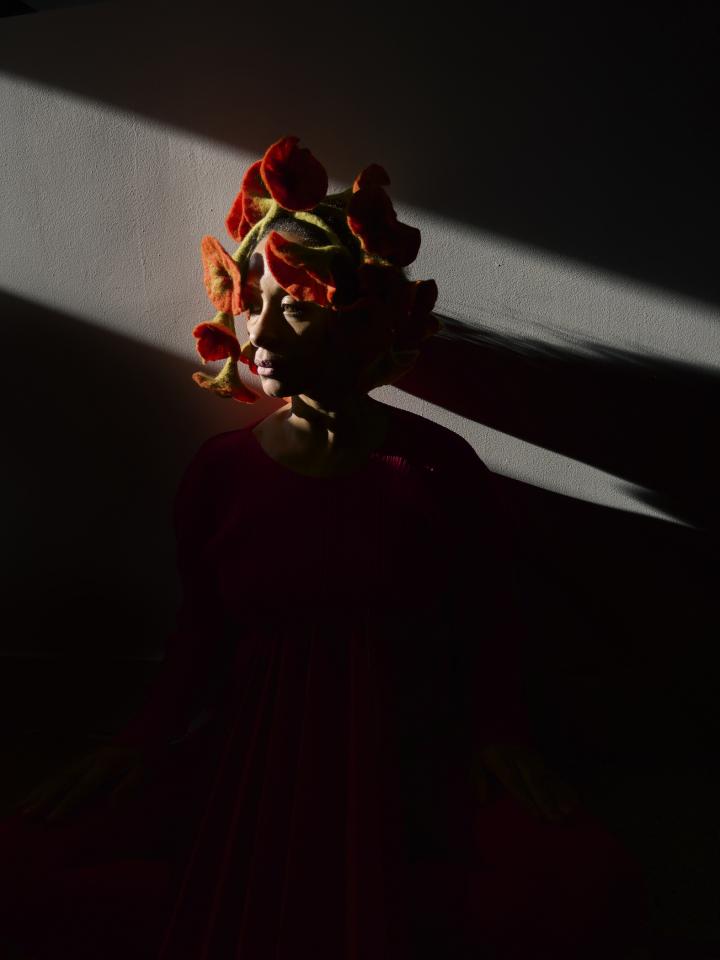 Photograph of a girl with a flower band.