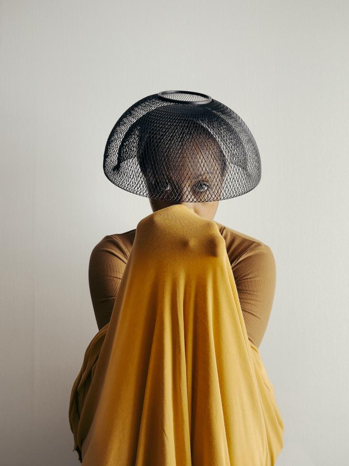 Photo of a girl with a bowl hat.