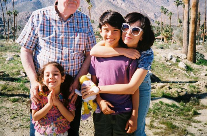 A family picture taken outside.