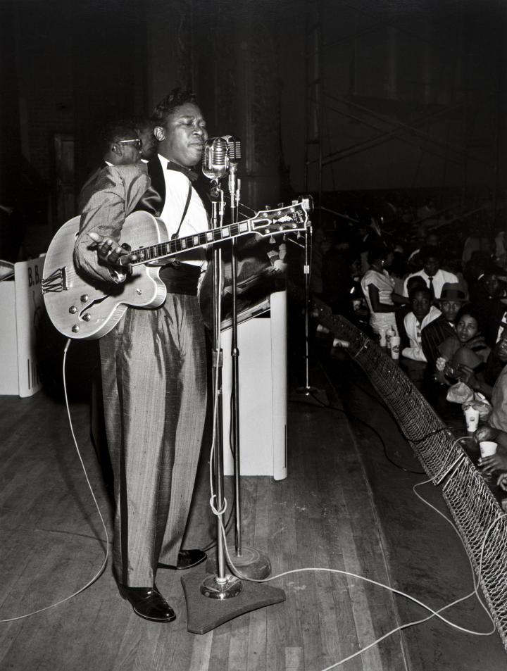 A man singing on stage.