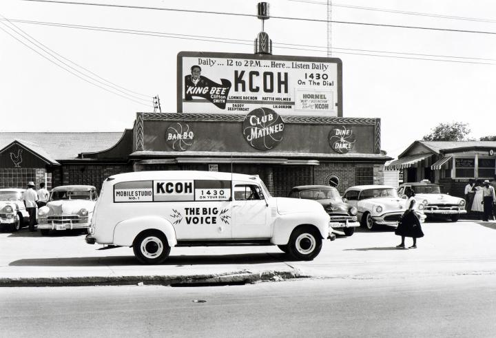 An antique photo with an antique car.