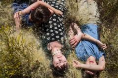 Sarah Blesener, Curtis, Kate and Jude, all of whom are homeschooled, lay in their backyard on a dry, hot summer afternoon. Watford, North Dakota, from the series Beckon Us from Home. © Sarah Blesener, Courtesy Anastasia Photo, New York 