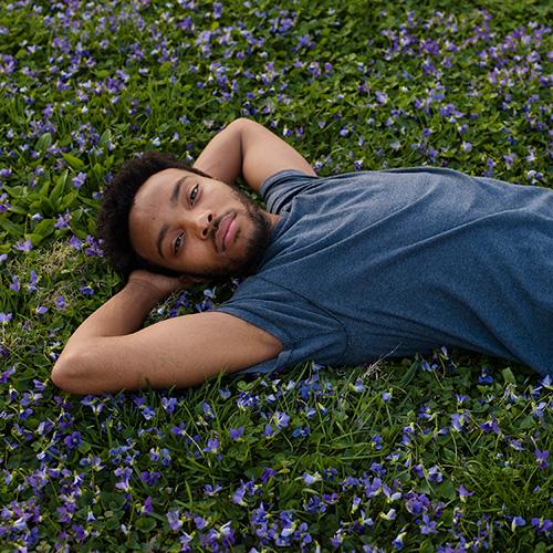 A man relaxing on the grass.