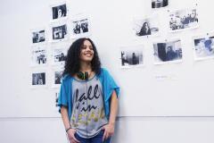 A girl in front of a white board with pictures.