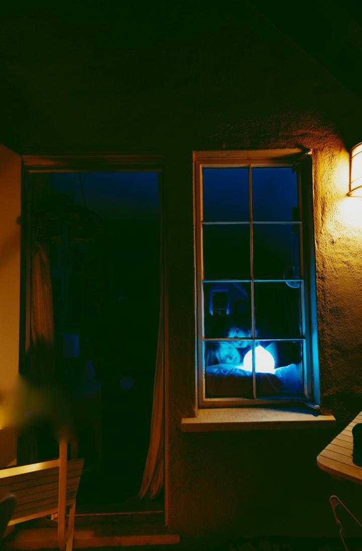 Two girls looking outside the window.