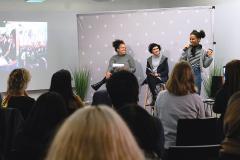 A group of woman giving a presentation.