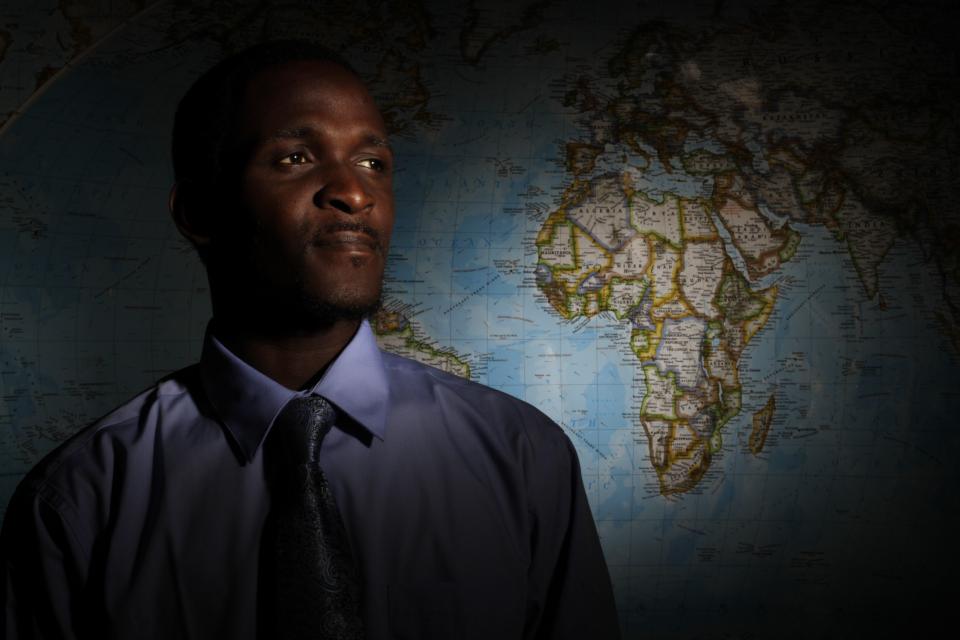 A man standing in front of a map.