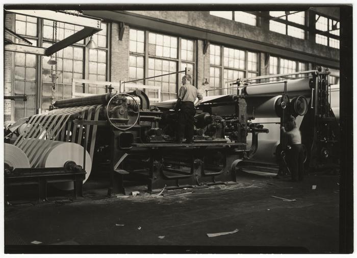 A man standing next to a machine.