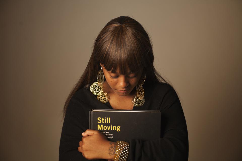 A woman holding a book.