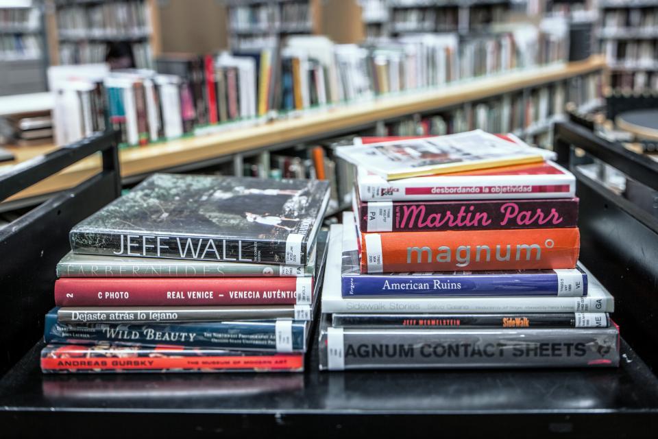 A stack of books on a cart.