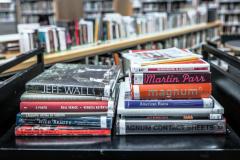 A stack of books on a cart.