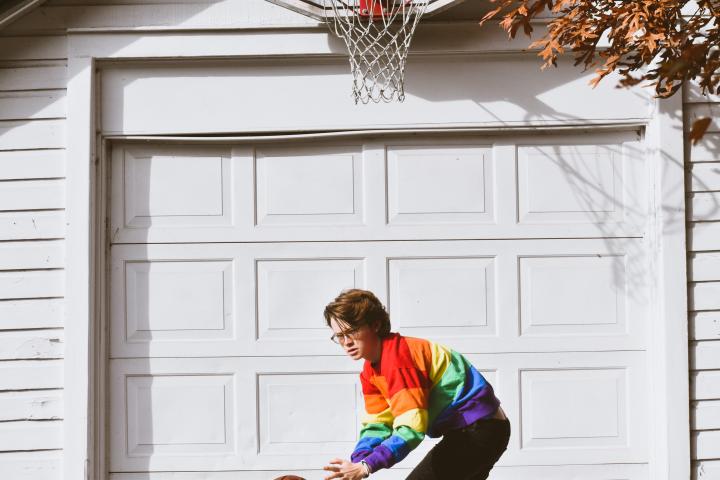 Kid playing basketball in the garage