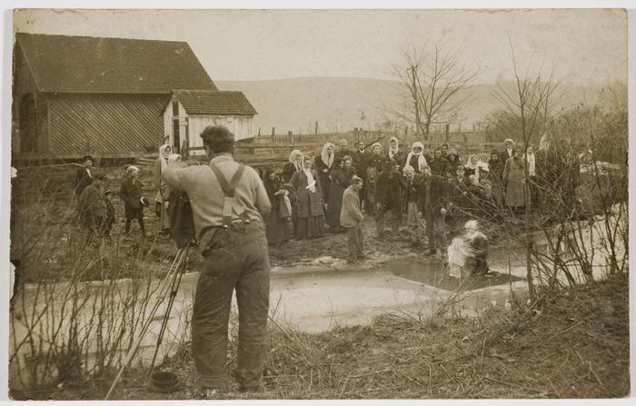 An antique photo of people outside.