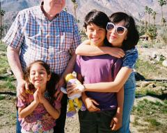 A family picture taken outside.